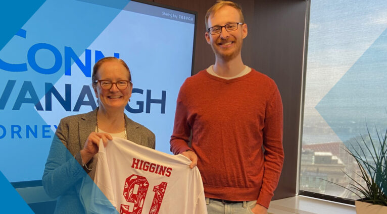 Erin Higgins with a jersey presentation by the Boston College Law School Softball team, the Legal Eagles