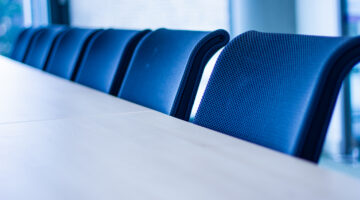Row of office chairs in a meeting room shot from an angle